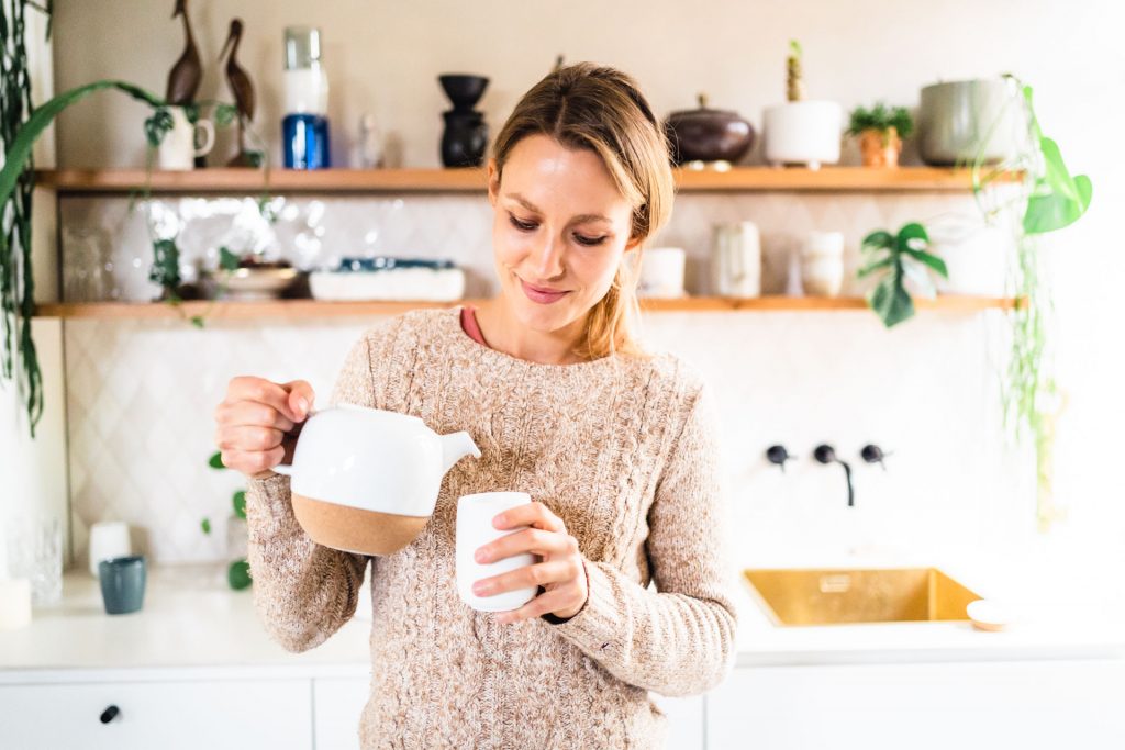 Frau gießt Tee ein bei Produkt Foto Shooting